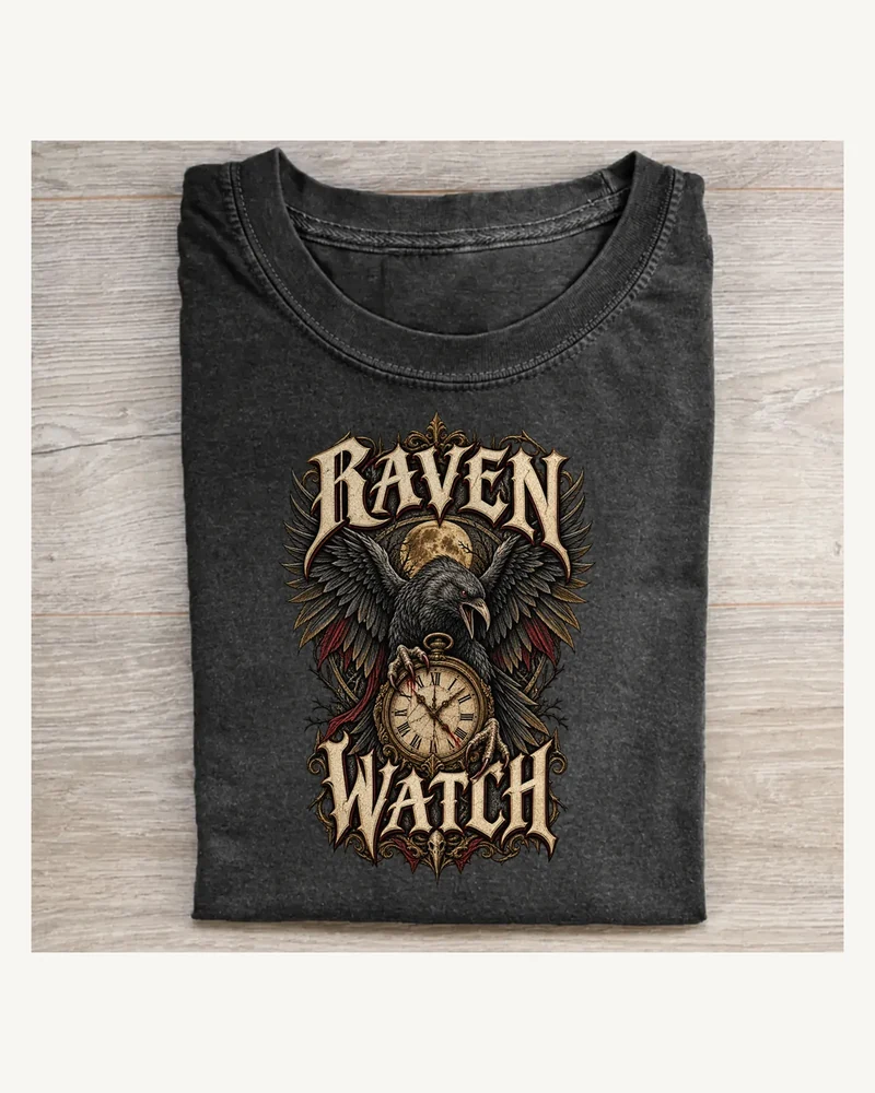 Folded washed black T-shirt featuring RAVEN WATCH gothic lettering and Halloween artwork