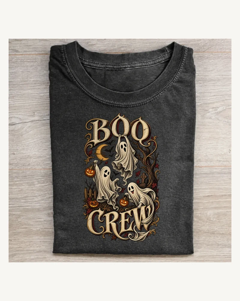 Folded washed black T-shirt featuring BOO CREW gothic lettering and Halloween artwork