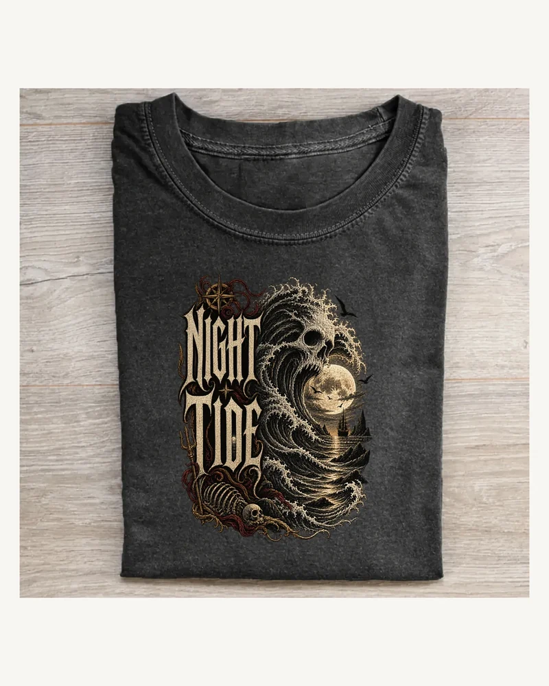Folded washed black T-shirt featuring NIGHT TIDE gothic lettering and Halloween artwork