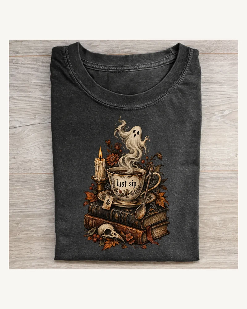Folded washed black T-shirt featuring Last Sip gothic artwork