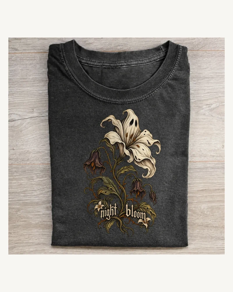 Folded washed black T-shirt featuring Night Bloom gothic artwork