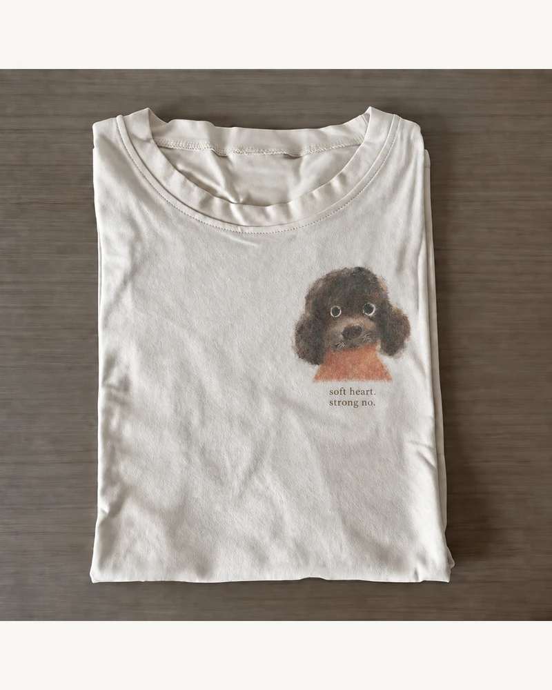 Folded white cotton T-shirt featuring Soft Heart. Strong No. Dog T-Shirt