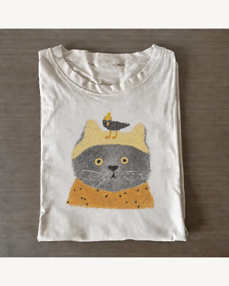 Folded white cotton T-shirt featuring Little Bird Cat T-Shirt