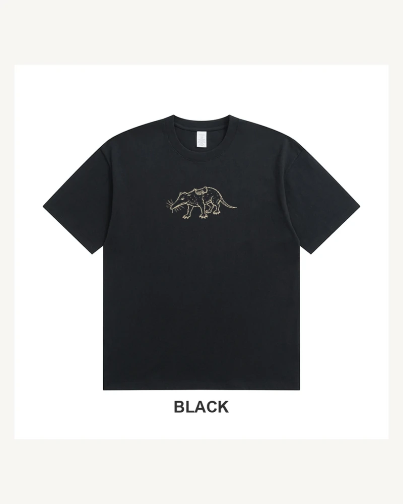 Black drop-shoulder cotton T-shirt with a small warm-cream odd mammal anatomy line drawing