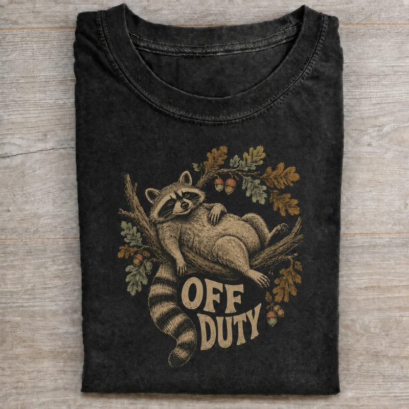 Folded washed black T-shirt with off duty raccoon artwork